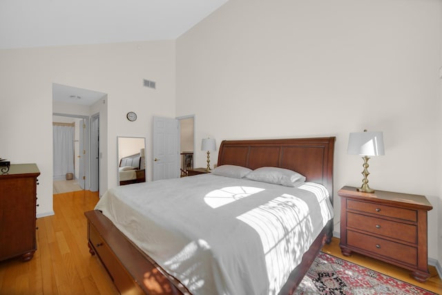 679 Prestwick Ln, Wheeling, IL 60090 - bedroom featuring light wood-style floors, high vaulted ceiling, and baseboards
