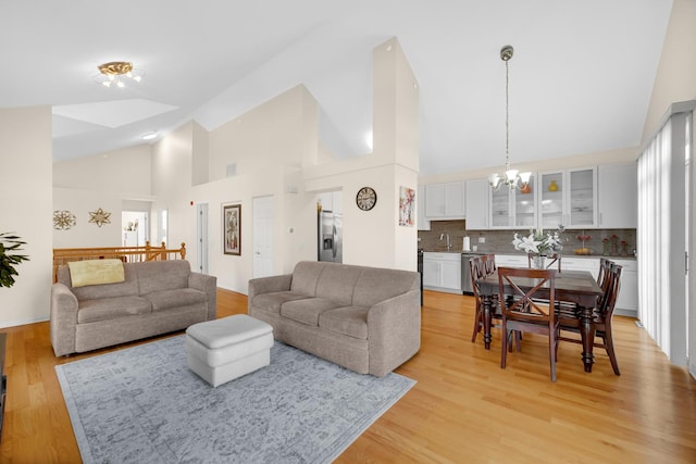679 Prestwick Ln, Wheeling, IL 60090 - living room with high vaulted ceiling, a chandelier, and light wood finished floors