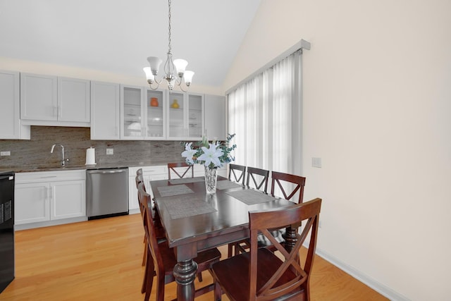 679 Prestwick Ln, Wheeling, IL 60090 - dining space featuring a chandelier, vaulted ceiling, and light wood-type flooring