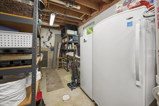 175 N Dogwood St, Cortland, IL 60112 - below grade area featuring freestanding refrigerator and a workshop area
