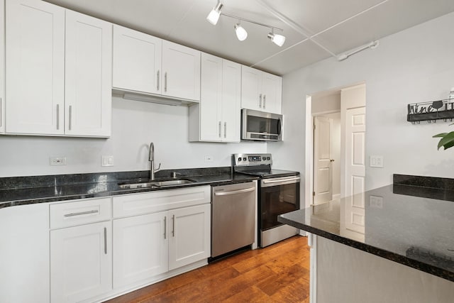 9737 N Fox Glen Dr Unit 5C, Niles, IL 60714 - kitchen with appliances with stainless steel finishes, a sink, white cabinetry, rail lighting, and dark wood-style flooring