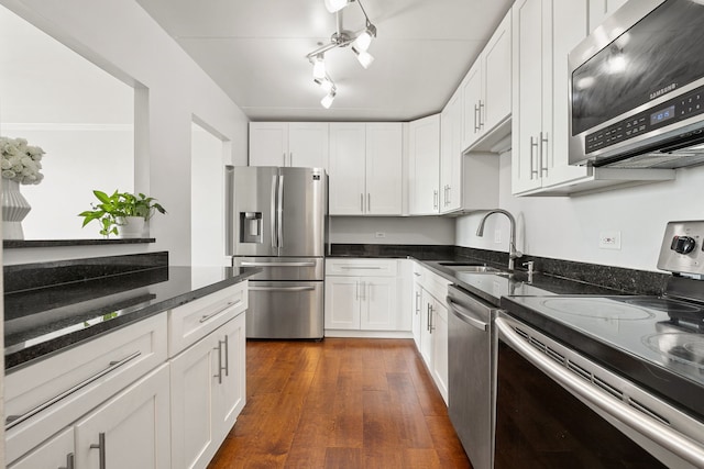 9737 N Fox Glen Dr Unit 5C, Niles, IL 60714 - kitchen with appliances with stainless steel finishes, white cabinetry, dark stone counters, and a sink