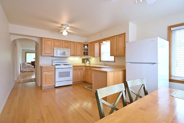 7513 W Isham Ave, Chicago, IL 60631 - kitchen featuring white appliances, a ceiling fan, light countertops, light wood-type flooring, and arched walkways