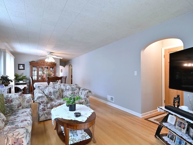 7513 W Isham Ave, Chicago, IL 60631 - living area featuring arched walkways, light wood-style flooring, ceiling fan, and baseboards