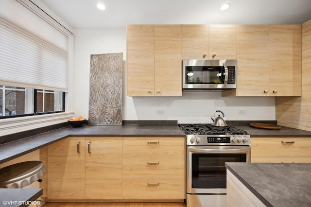 734 Noyes St Unit L1, Evanston, IL 60201 - kitchen with appliances with stainless steel finishes, light brown cabinets, dark countertops, and recessed lighting