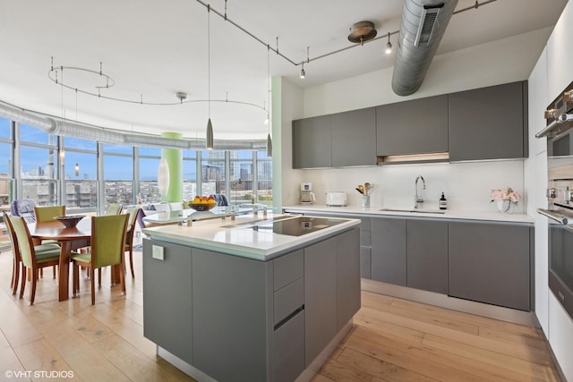 1200 W Monroe St Unit 808, Chicago, IL 60607 - kitchen with gray cabinetry, a sink, modern cabinets, black electric cooktop, and light countertops