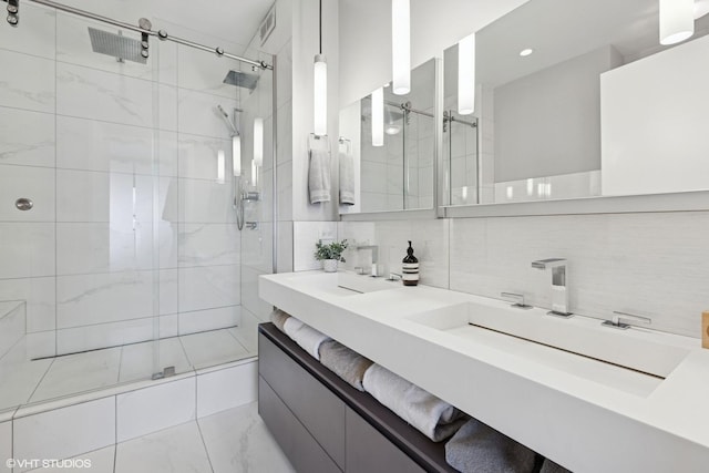 1200 W Monroe St Unit 808, Chicago, IL 60607 - bathroom with a tile shower, double vanity, backsplash, marble finish floors, and recessed lighting