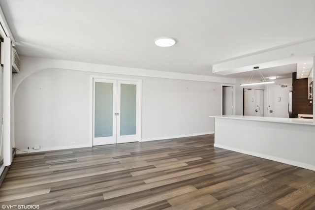300 N State St Unit 4930, Chicago, IL 60654 - unfurnished living room featuring french doors, wood finished floors, and baseboards