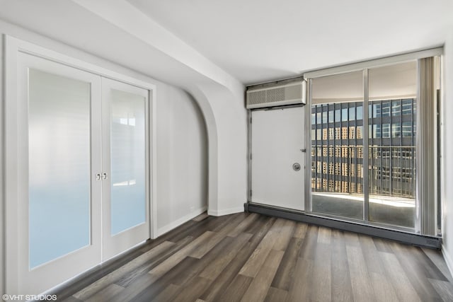 300 N State St Unit 4930, Chicago, IL 60654 - unfurnished room with dark wood-style flooring, a wall mounted AC, and french doors
