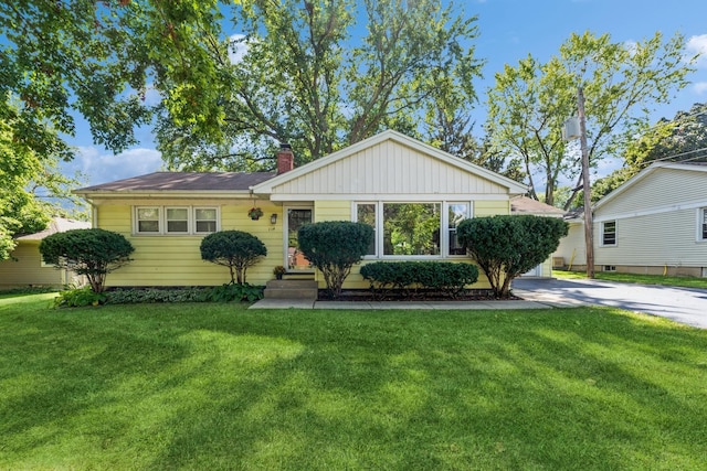 114 Washington St, Bloomingdale, IL 60108 - view of front of house with entry steps, a front yard, and a chimney