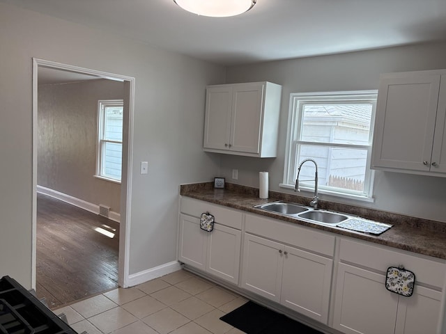 926 Park Ave, Winthrop Harbor, IL 60096 - kitchen with healthy amount of natural light, white cabinets, and dark countertops