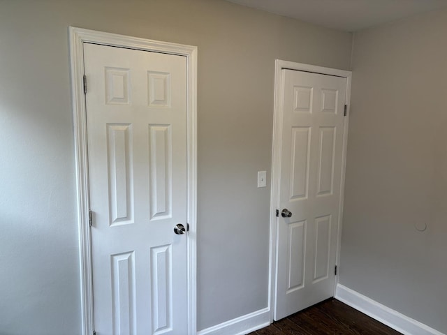 926 Park Ave, Winthrop Harbor, IL 60096 - unfurnished bedroom with baseboards and dark wood-style flooring