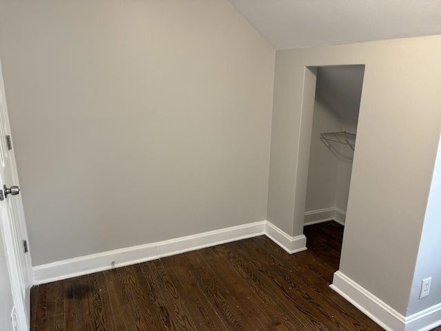926 Park Ave, Winthrop Harbor, IL 60096 - unfurnished bedroom with dark wood-type flooring, baseboards, and vaulted ceiling