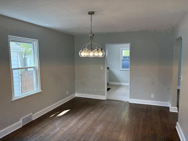 926 Park Ave, Winthrop Harbor, IL 60096 - unfurnished dining area featuring wood finished floors, a chandelier, healthy amount of natural light, and baseboards