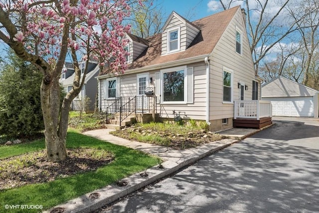 1552 Mccraren Rd, Highland Park, IL 60035 - cape cod house featuring an outbuilding, a detached garage, and a shingled roof