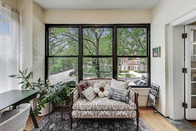 5143 S Greenwood Ave Unit 1, Chicago, IL 60615 - sunroom with wood finished floors, healthy amount of natural light, and brick wall