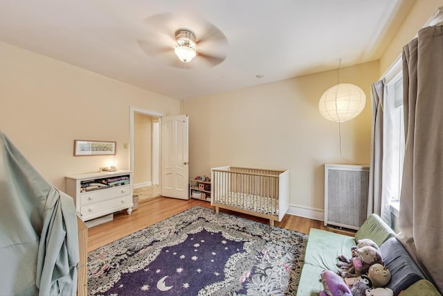 5143 S Greenwood Ave Unit 1, Chicago, IL 60615 - bedroom with wood finished floors, ceiling fan, and a crib