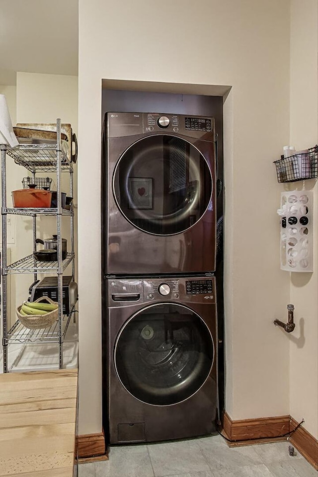 5143 S Greenwood Ave Unit 1, Chicago, IL 60615 - washroom featuring stacked washer / dryer and tile patterned flooring