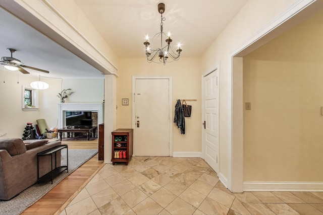 5143 S Greenwood Ave Unit 1, Chicago, IL 60615 - foyer entrance featuring a chandelier, ceiling fan, and a fireplace