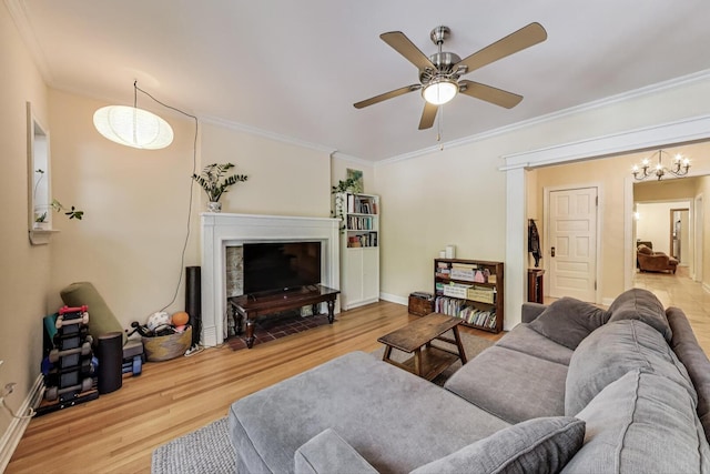5143 S Greenwood Ave Unit 1, Chicago, IL 60615 - living room featuring wood finished floors, ornamental molding, a ceiling fan, and a chandelier
