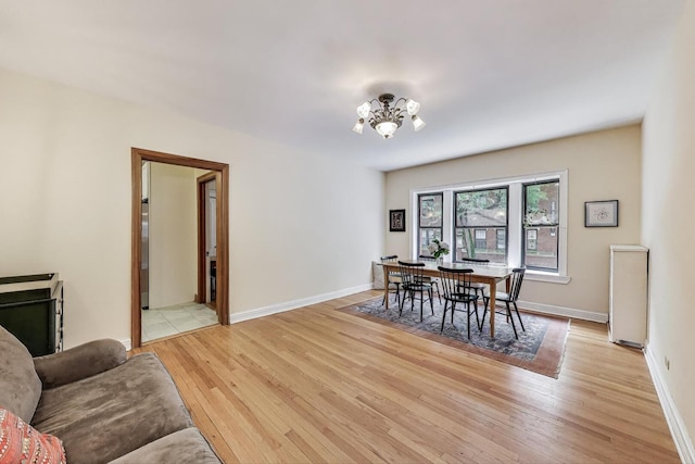 5143 S Greenwood Ave Unit 1, Chicago, IL 60615 - dining area featuring light wood-type flooring and a chandelier