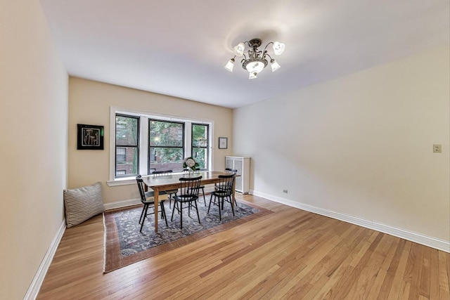 5143 S Greenwood Ave Unit 1, Chicago, IL 60615 - dining room with a chandelier and light wood-style flooring
