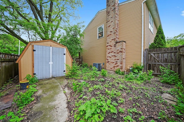 1136 S Naper Blvd, Naperville, IL 60540 - rear view of property with a fenced backyard, a chimney, and central AC unit
