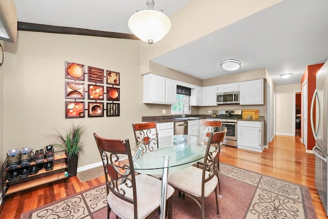 1136 S Naper Blvd, Naperville, IL 60540 - dining area with light wood-style floors, baseboards, and vaulted ceiling