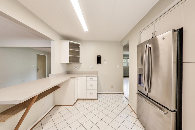 6478 N NW Hwy Unit 1, Chicago, IL 60631 - kitchen with stainless steel fridge, light countertops, white cabinetry, and baseboards