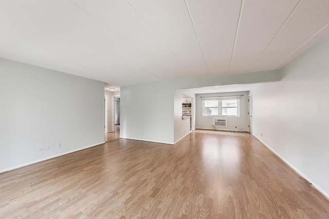 6478 N NW Hwy Unit 1, Chicago, IL 60631 - spare room with light wood finished floors, a wall unit AC, and baseboards