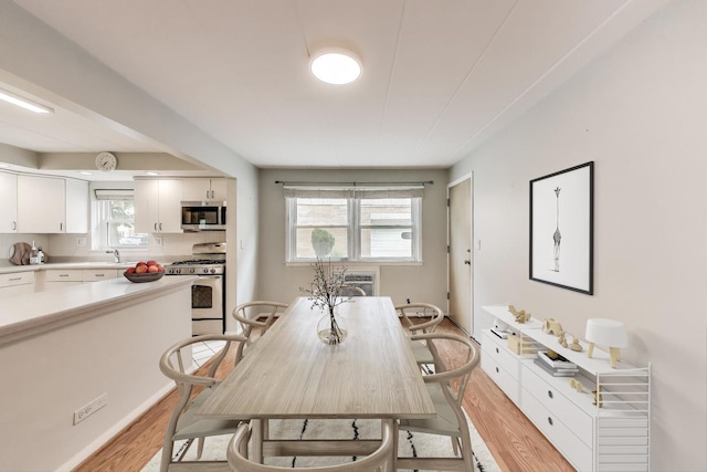 6478 N NW Hwy Unit 1, Chicago, IL 60631 - dining room with light wood-style floors, plenty of natural light, and a wall unit AC