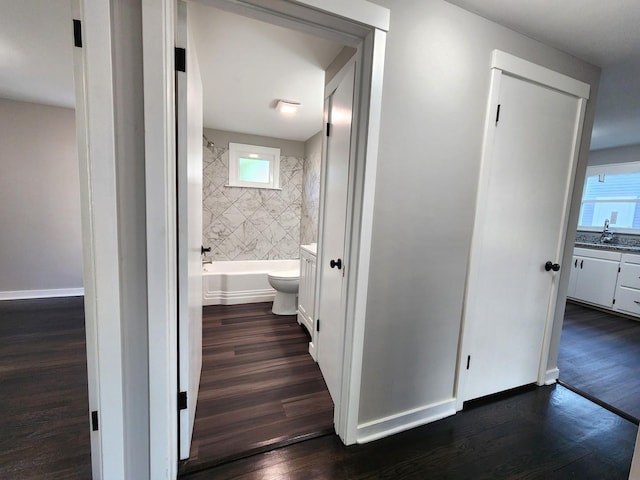673 Slade Ave, Elgin, IL 60120 - hall with dark wood finished floors, baseboards, and a sink