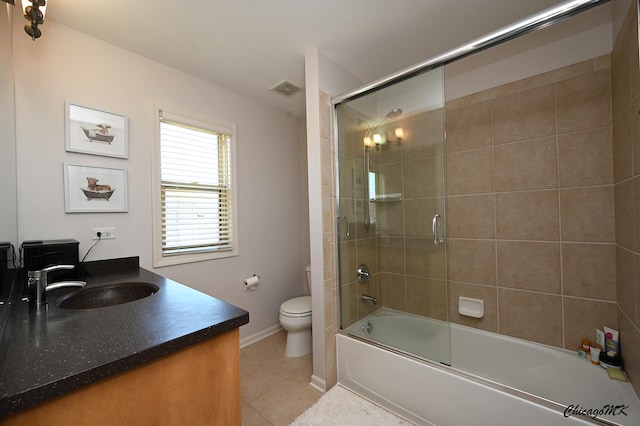 328 Erie Cir, Bloomingdale, IL 60108 - bathroom featuring toilet, vanity, tile patterned flooring, shower / bath combination with glass door, and baseboards