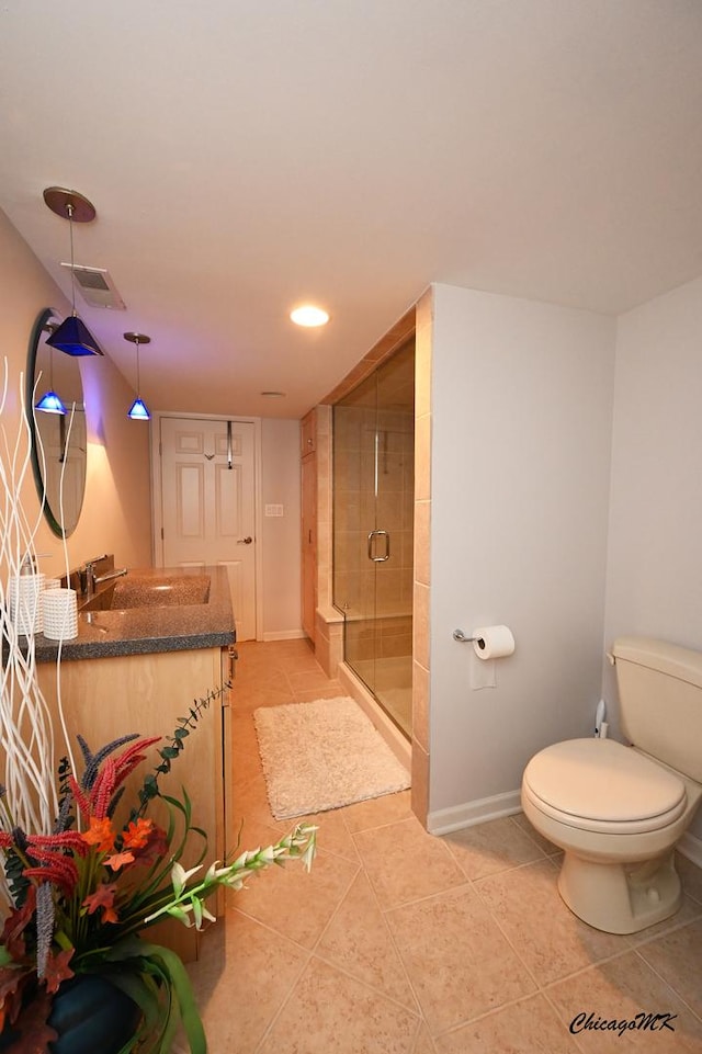 328 Erie Cir, Bloomingdale, IL 60108 - bathroom featuring vanity, tile patterned floors, baseboards, a stall shower, and toilet