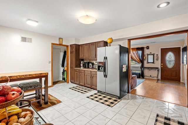 125 Seton Pl, Streamwood, IL 60107 - kitchen featuring stainless steel fridge, light countertops, and light tile patterned floors