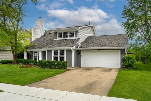 820 N Dexter Ln, Hoffman Estates, IL 60169 - view of front of property with an attached garage, a front yard, a chimney, and driveway