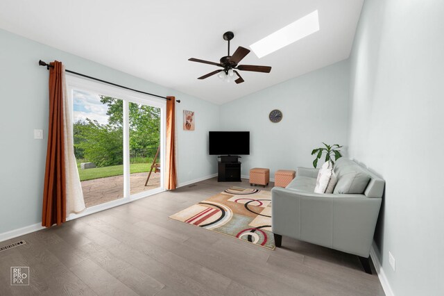 820 N Dexter Ln, Hoffman Estates, IL 60169 - living area with lofted ceiling, wood finished floors, ceiling fan, a skylight, and baseboards