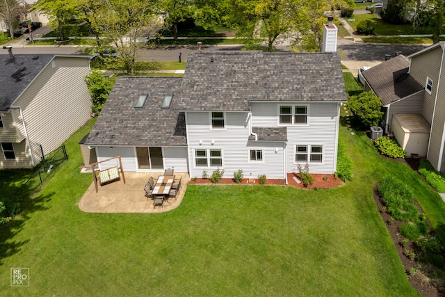 820 N Dexter Ln, Hoffman Estates, IL 60169 - back of property with a patio, a lawn, a shingled roof, and a chimney