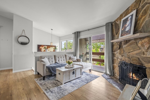 5 Cobblestone Ct Unit C, Palos Hills, IL 60465 - living area featuring lofted ceiling, a stone fireplace, light wood-style flooring, and baseboards