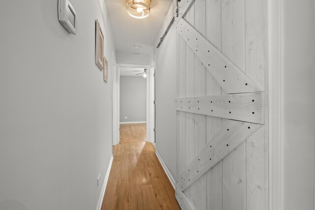 5 Cobblestone Ct Unit C, Palos Hills, IL 60465 - corridor featuring light wood-style floors, baseboards, and a barn door