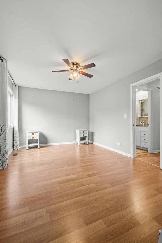 5 Cobblestone Ct Unit C, Palos Hills, IL 60465 - unfurnished living room featuring a ceiling fan, light wood-style floors, and baseboards
