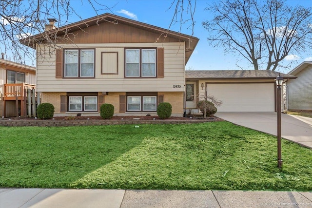 15435 Orogrande Dr, Oak Forest, IL 60452 - split level home featuring driveway, an attached garage, brick siding, a front lawn, and a chimney