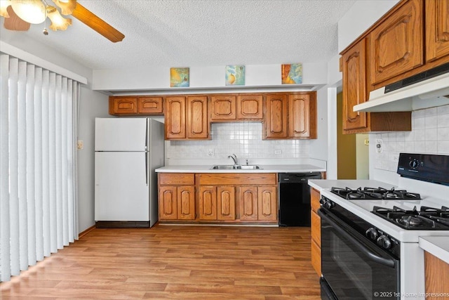 15435 Orogrande Dr, Oak Forest, IL 60452 - kitchen featuring freestanding refrigerator, range with gas stovetop, black dishwasher, brown cabinetry, and a sink