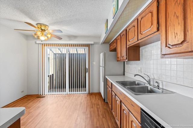 15435 Orogrande Dr, Oak Forest, IL 60452 - kitchen with a sink, baseboards, freestanding refrigerator, light countertops, and a textured ceiling