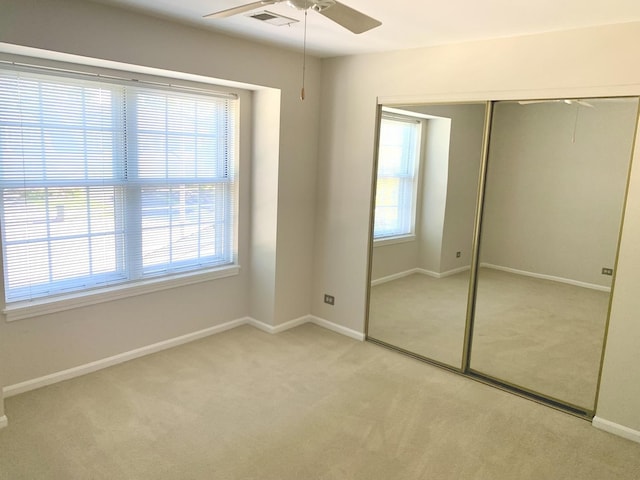 1422 W Orchard Pl Unit B, Arlington Heights, IL 60005 - unfurnished bedroom featuring carpet floors, multiple windows, a closet, and baseboards