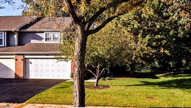 1422 W Orchard Pl Unit B, Arlington Heights, IL 60005 - view of front facade with a garage, a front lawn, brick siding, asphalt driveway, and a shingled roof