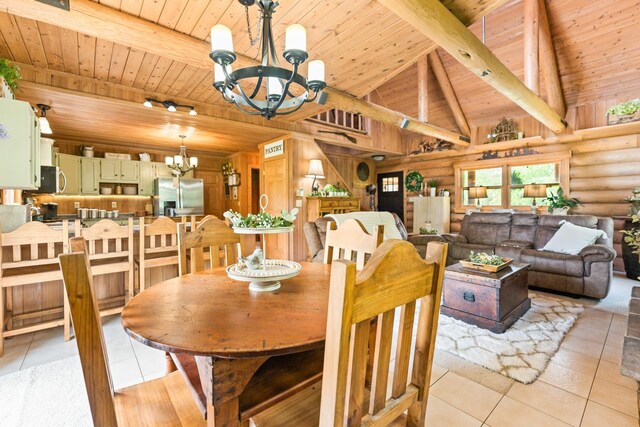 310 N Oak Ln, Dixon, IL 61021 - dining area with a chandelier, wood ceiling, rustic walls, and light tile patterned floors