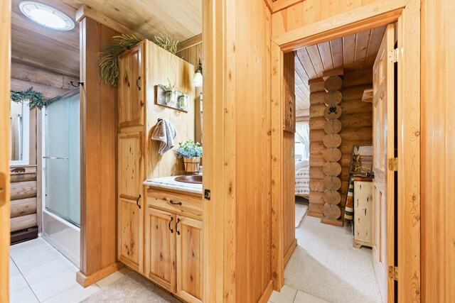 310 N Oak Ln, Dixon, IL 61021 - full bath with rustic walls, wood ceiling, tile patterned floors, vanity, and shower / bath combination with glass door