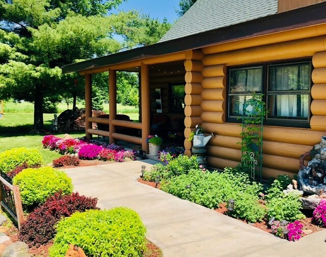 310 N Oak Ln, Dixon, IL 61021 - entrance to property with log exterior and a shingled roof