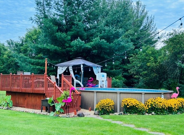 310 N Oak Ln, Dixon, IL 61021 - view of green lawn with a deck and an outdoor pool